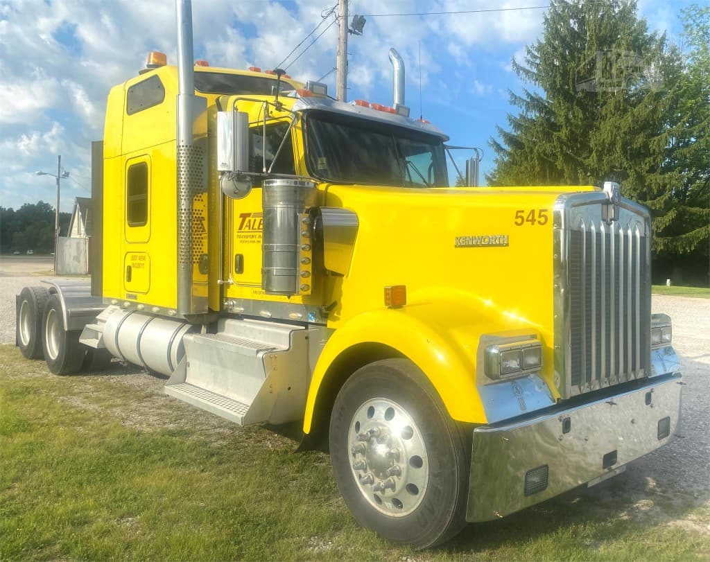 Bright yellow Kenworth semi-truck tractor parked outdoors
